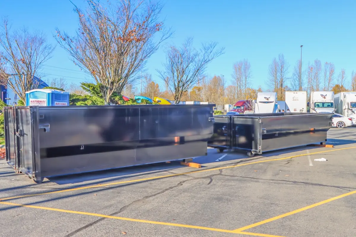 Professional dumpster rental service with roll-off container on residential driveway in Tracy